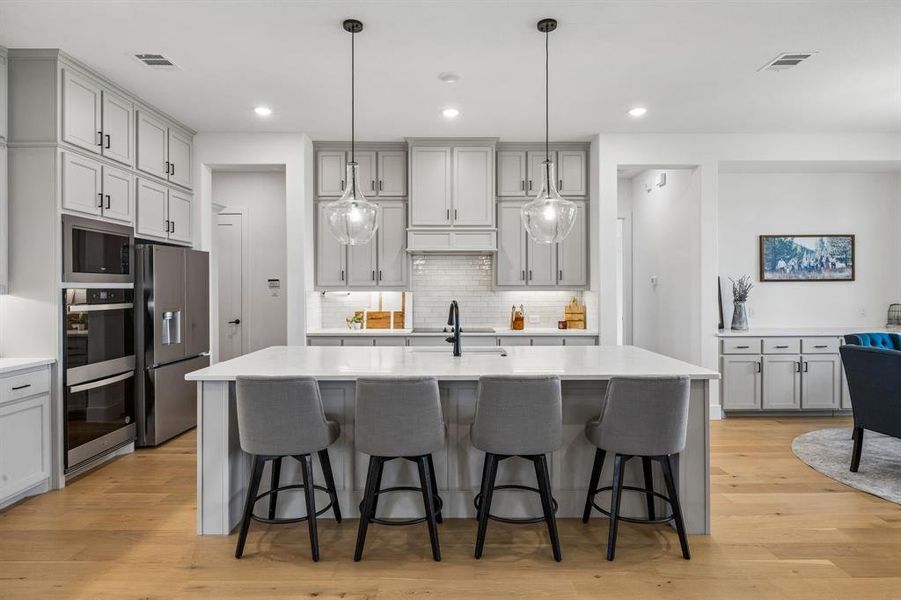 This kitchen is a showstopper with so much cabinet space & quartz counters.