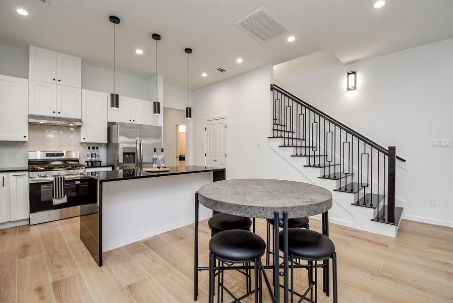 The seamless kitchen and dining area enhances the home's open flow.