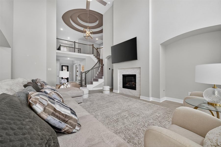 This spacious great room offers a perfect blend of comfort and connectivity with a direct view into the upstairs landing. Clean lines and modern accents enhance the home's stylish layout.