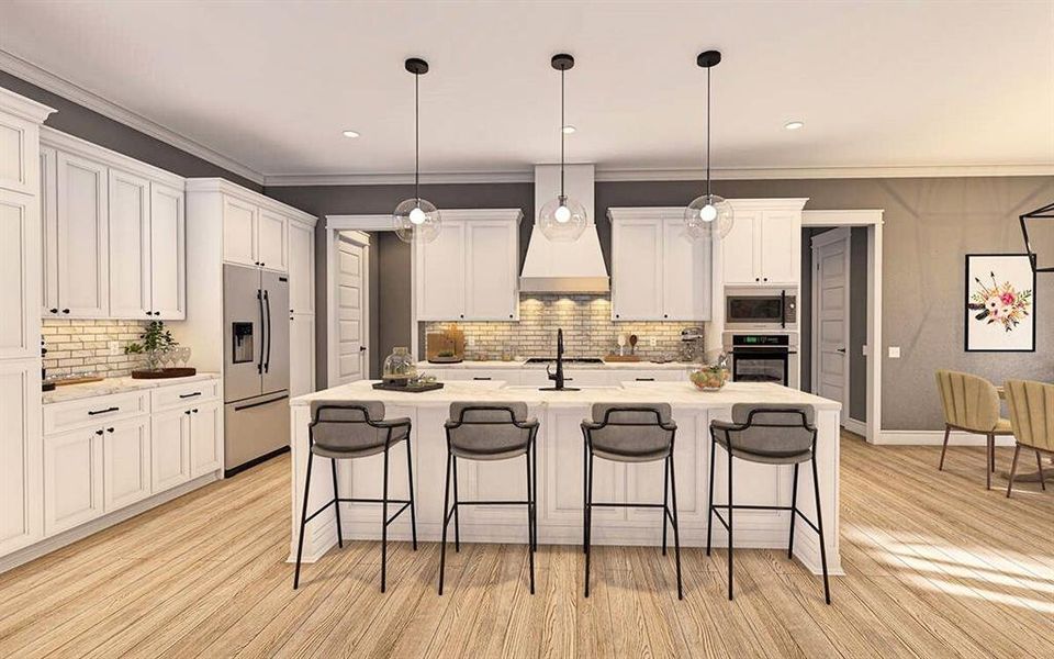 Kitchen featuring ornamental molding, a breakfast bar, a kitchen island with sink, white cabinets, and built in appliances Kitchen featuring ornamental molding, a breakfast bar, a kitchen island with sink, white cabinets, and built in appliances