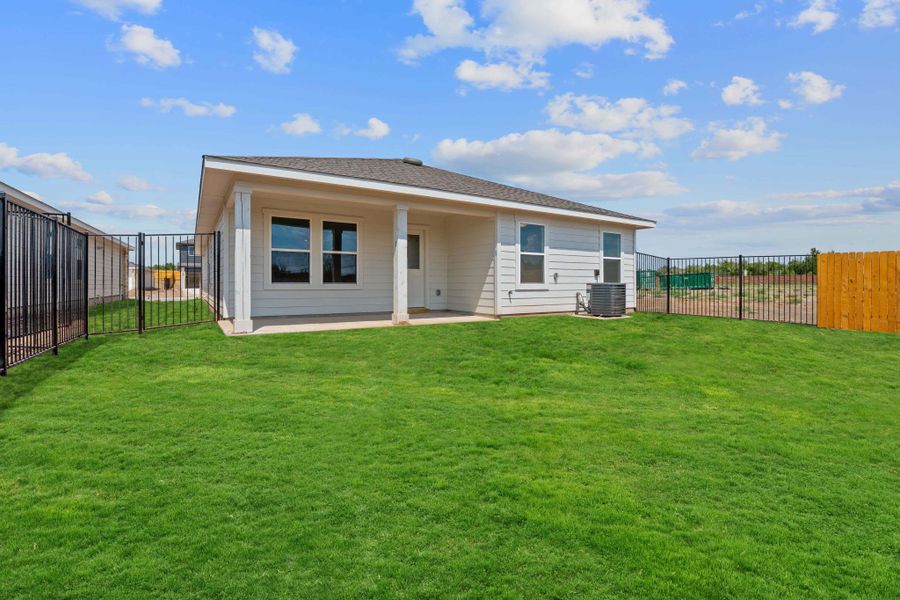 Rear view of house with a fenced backyard, a patio area, and a shingled roof Rear view of house with a fenced backyard, a patio area, and a shingled roof