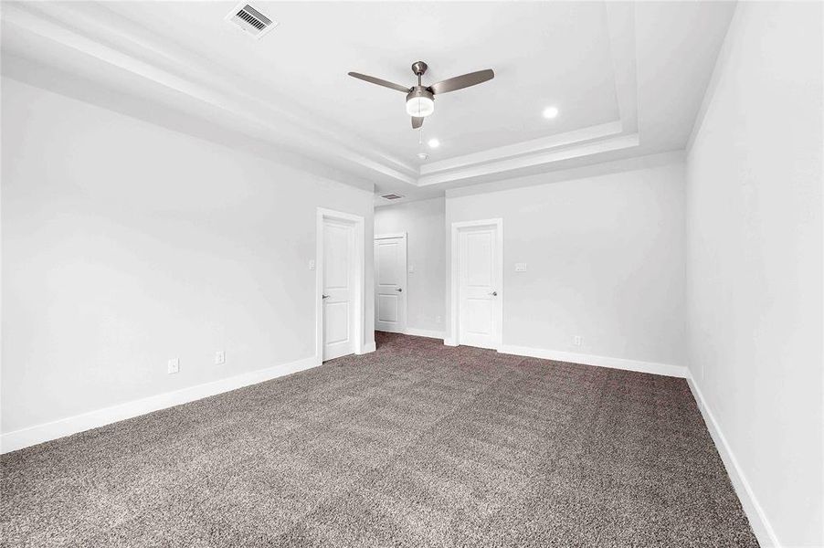 Primary bedroom with vaulted ceilings