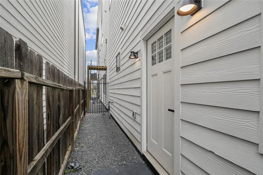 The backyard features a wrought iron fence and space for your pet or garden.