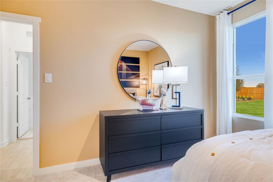 Bedroom with light carpet and baseboards