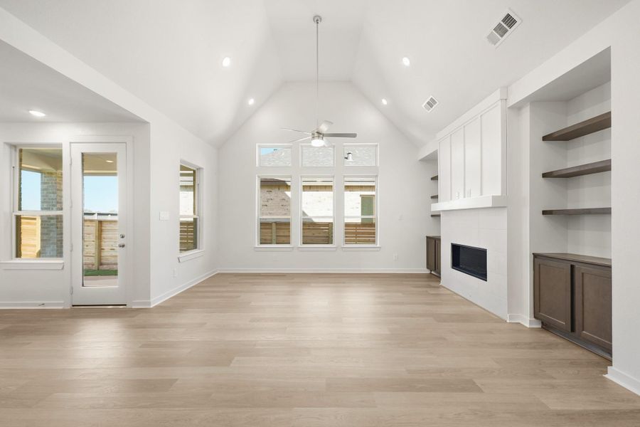 A stunning family room with high ceilings, abundant natural light, and expansive windows that create an open and airy atmosphere. A stunning family room with high ceilings, abundant natural light, and expansive windows that create an open and airy atmosphere.