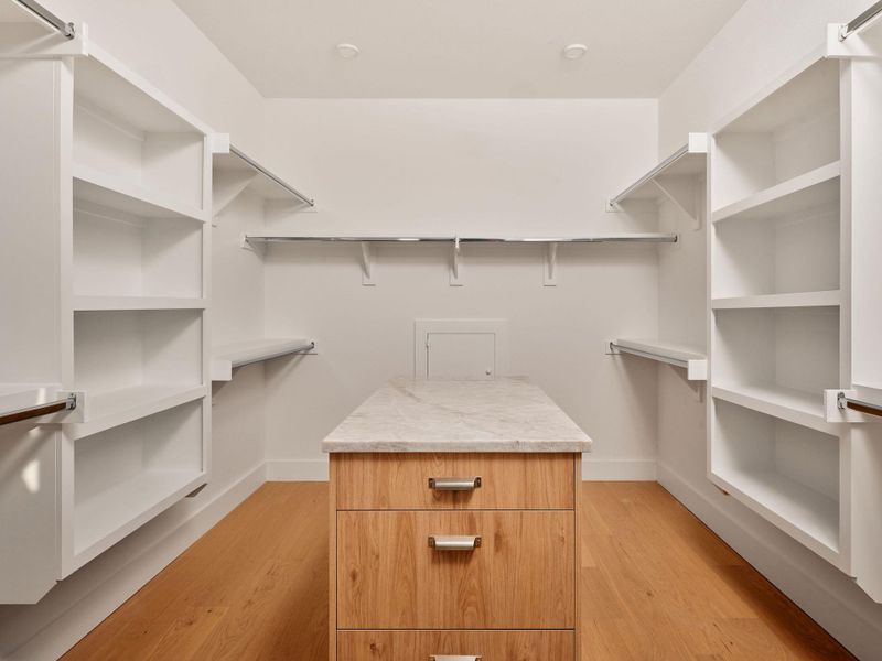 Walk in closet with light wood finished floors