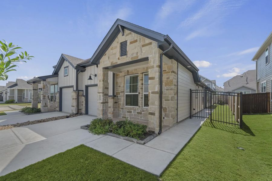 Representative exterior photo of a completed home built from the Carriagehouse by Chesmar Homes in Meridiana Townhomes, Iowa Colony, TX (Image 33).