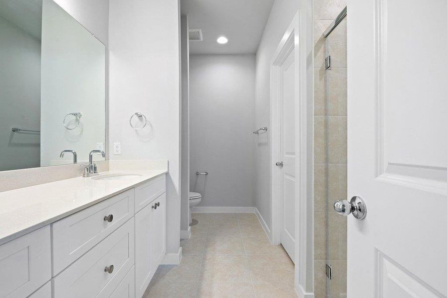Bathroom with vanity, recessed lighting, a shower stall, and light tile patterned floors