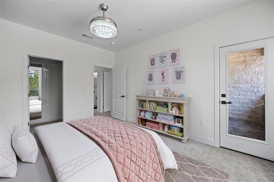 Carpeted bedroom featuring a chandelier