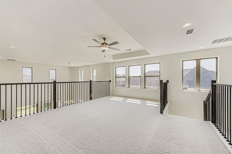 Carpeted spare room featuring a ceiling fan, recessed lighting, and a tray ceiling Carpeted spare room featuring a ceiling fan, recessed lighting, and a tray ceiling