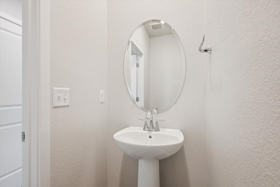 A bathroom with a round mirror. A bathroom with a round mirror.