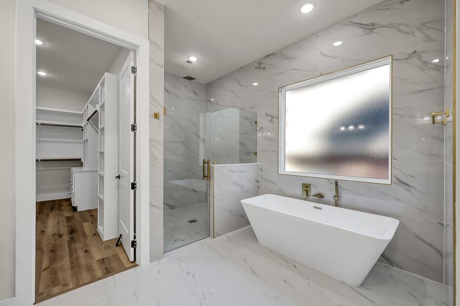 The owner’s retreat en-suite bathroom with access to the large walk-in closet.