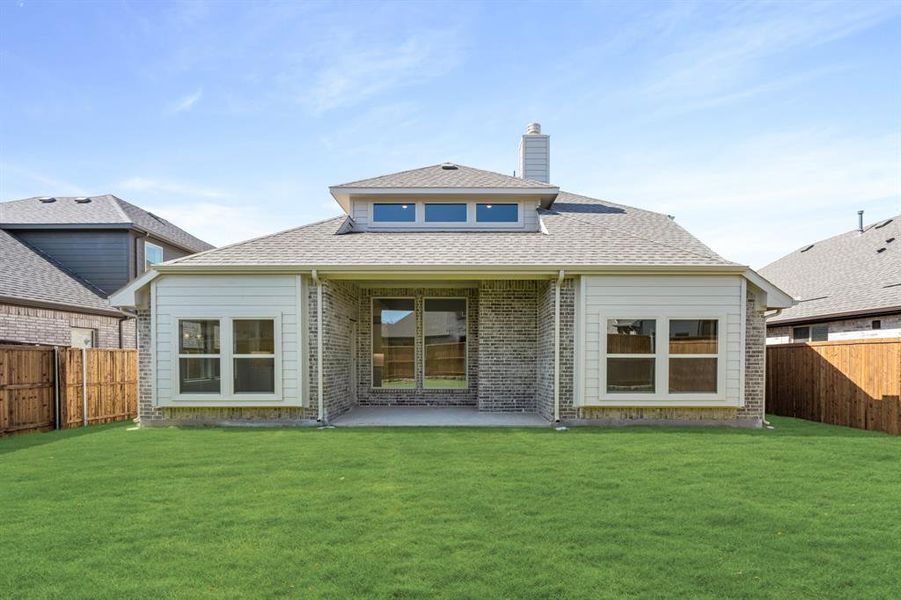 Front exterior of a new home in Woodstone, Providence Village, TX, highlighting curb appeal (Image 2).