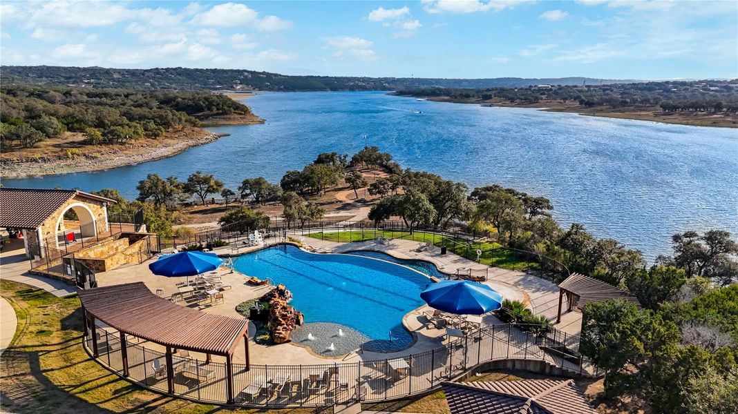 An inviting swimming pool overlooks sweeping water views surrounded by rolling hillsides. An inviting swimming pool overlooks sweeping water views surrounded by rolling hillsides.