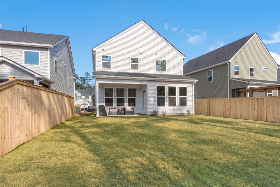Exterior details and patio area of a home in Jasmine Point at Lakes of Cane Bay, Summerville (Image 4).