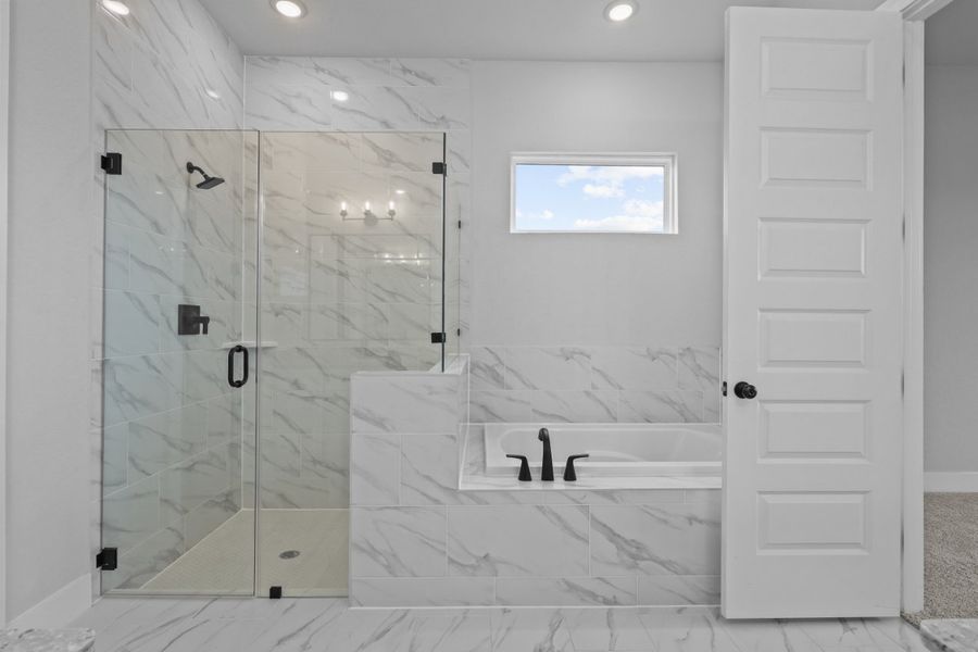 A bathroom with a glass shower. A bathroom with a glass shower.