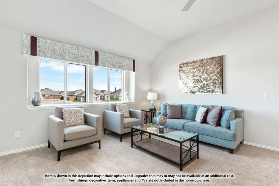 Living room with vaulted ceiling, blue sofa, two gray chairs, glass coffee table, and large windows with neighborhood view.