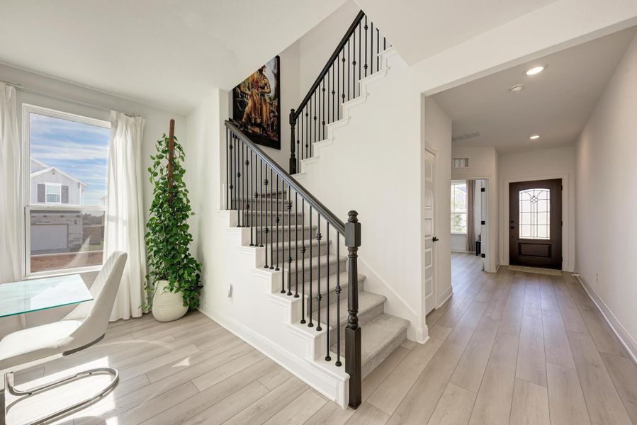 Entryway with light wood-style flooring, stairs, and recessed lighting