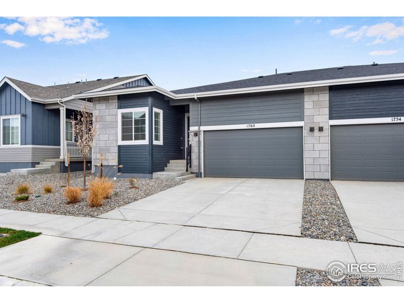 Front exterior of a new home in Westside Crossing Paired Homes, Berthoud, CO, highlighting curb appeal (Image 23).
