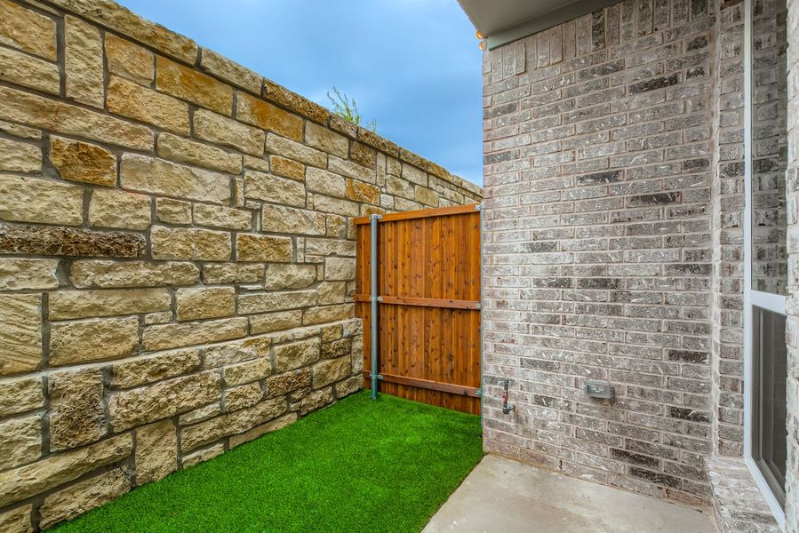 Exterior details and patio area of a home in Castle Hills Northpointe - Townhomes, Lewisville (Image 3).