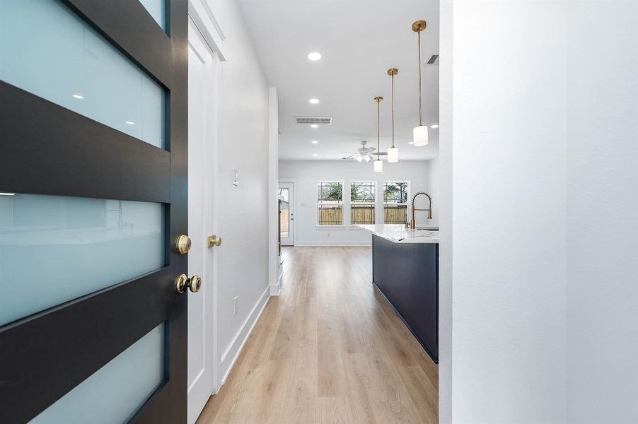 Galley-style layout highlighting sleek finishes, under-cabinet lighting, and a clean, functional design.