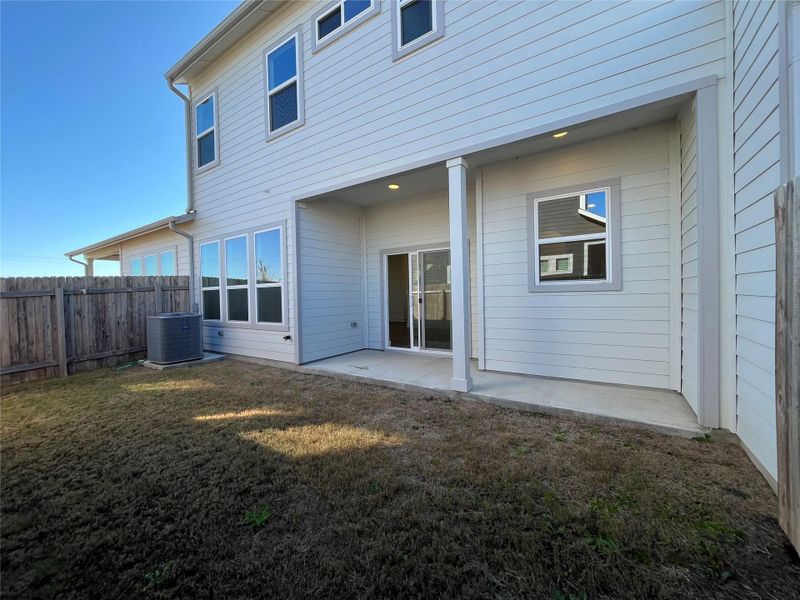 Fenced in backyard with large covered patio