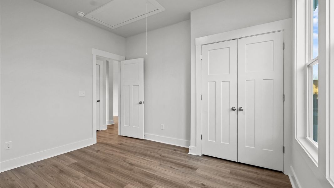 Desirable hardwood flooring in this bedroom creates a cohesive and elegant interior
