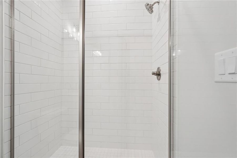 Full bathroom featuring a shower stall