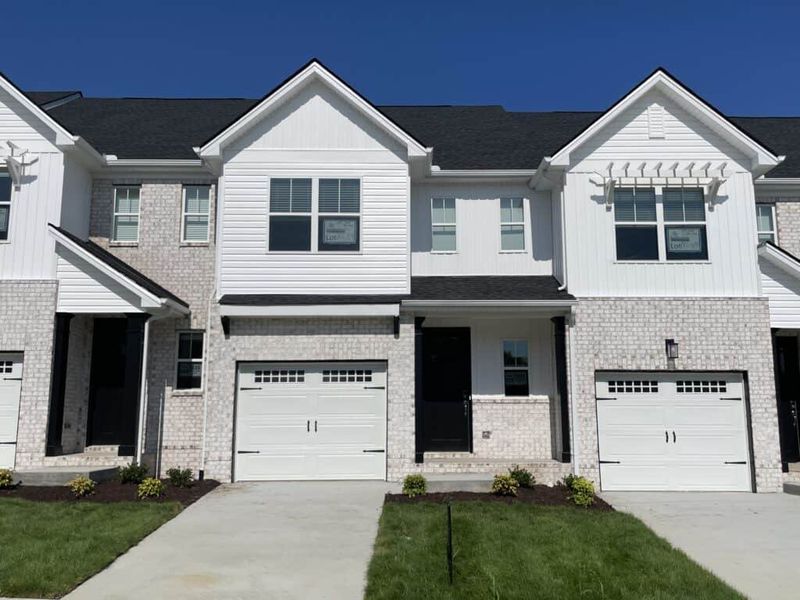 Front exterior of a new home in The Grove at Kennesaw Farms, Gallatin, TN, highlighting curb appeal (Image 1). Front exterior of a new home in The Grove at Kennesaw Farms, Gallatin, TN, highlighting curb appeal (Image 1).