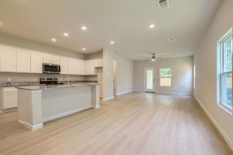 A large kitchen with white cabinets.