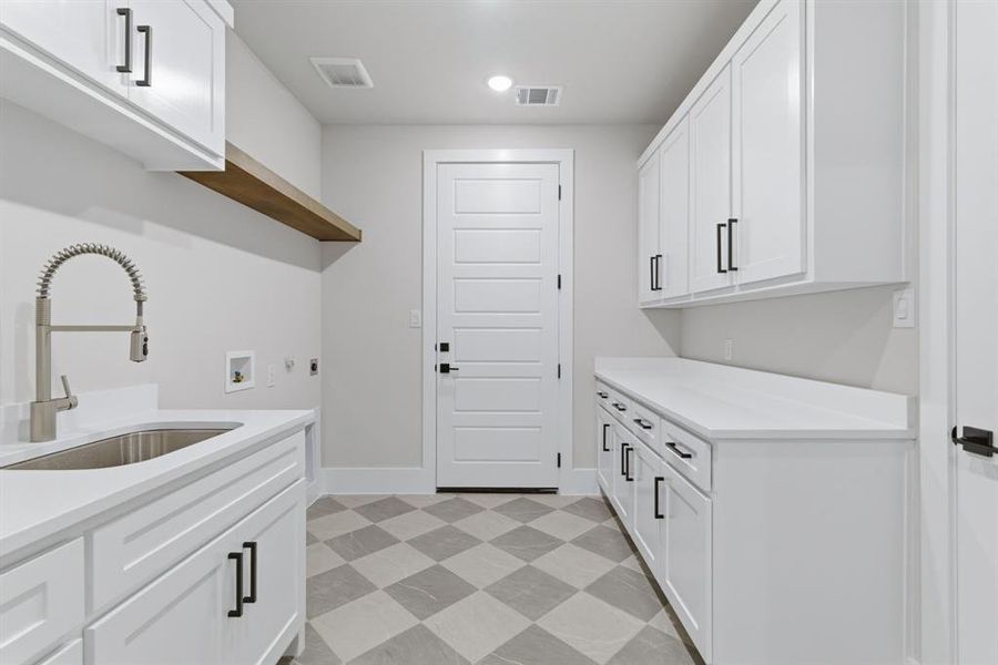 Laundry Room with Cabinetry, Sink, Storage and 1 Car Garage Access