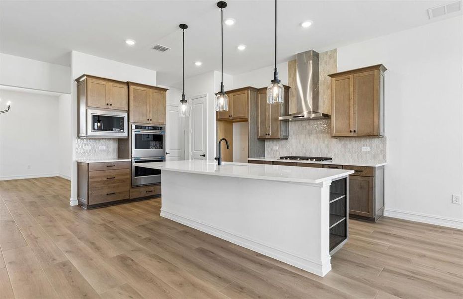 Eat-in island kitchen with pendant lighting