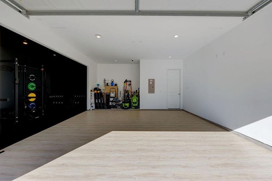 Garage featuring recessed lighting and electric panel