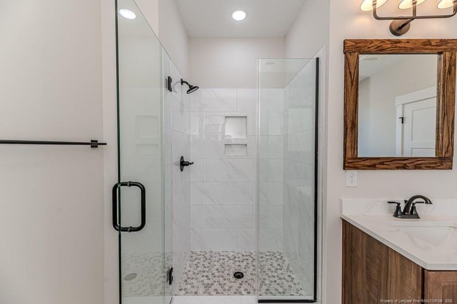 Tiled walk in shower with tiled niche