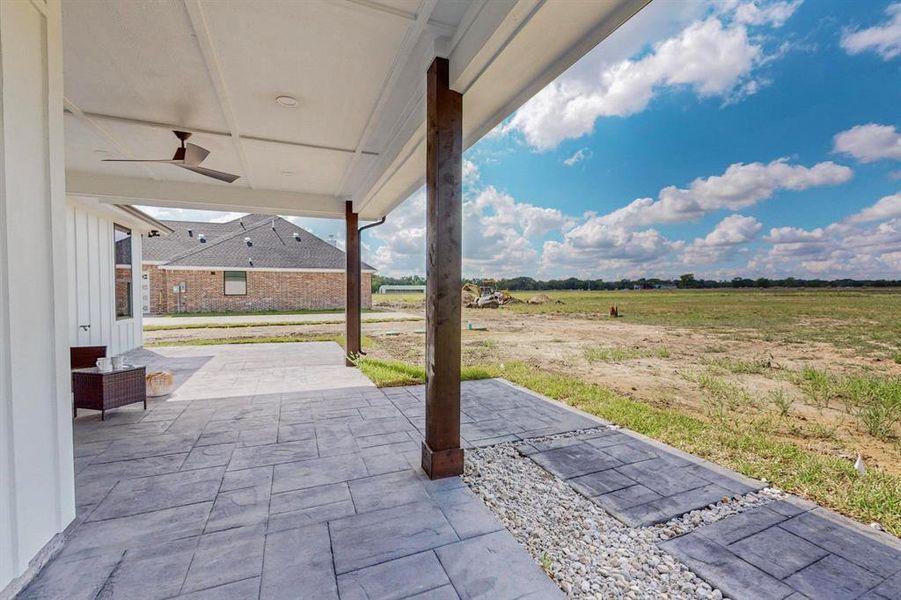 View of patio / terrace featuring ceiling fan and a rural view