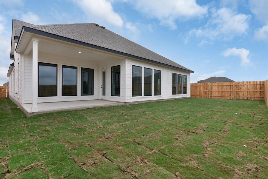 Rear view of house with a fenced backyard, a patio, and roof with shingles Rear view of house with a fenced backyard, a patio, and roof with shingles