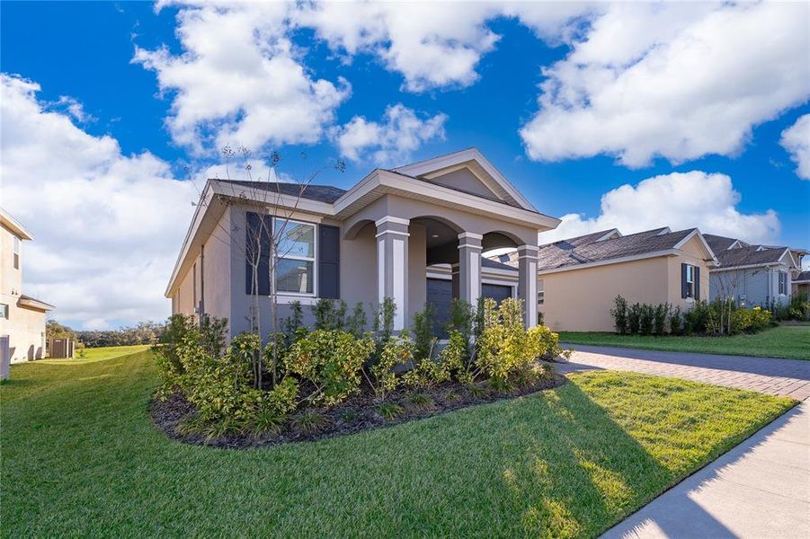 Front exterior of a new home in , Minneola, FL, highlighting curb appeal (Image 20).