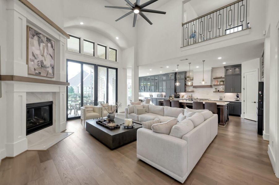 Open sightlines connect the living area to the kitchen for effortless flow while large windows invite natural light while maintaining a warm and comfortable atmosphere.