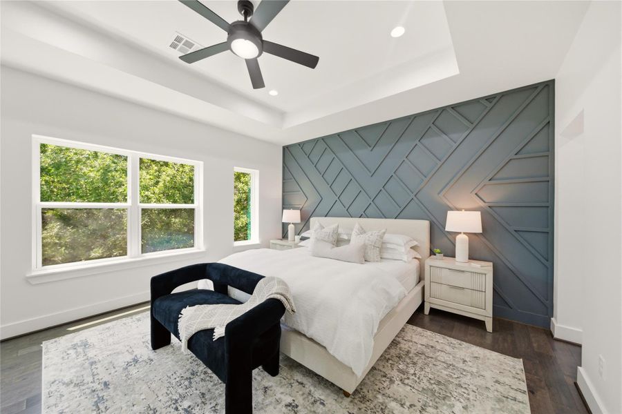 Primary suit boast modern accent wall and dark engineered wood floors. With bolted ceiling
