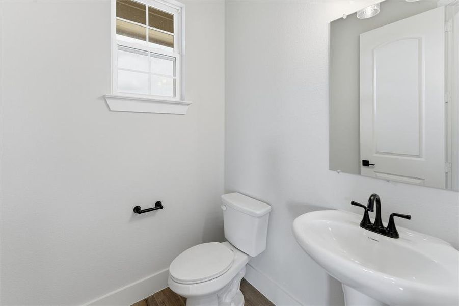 Bathroom with toilet and wood finished floors