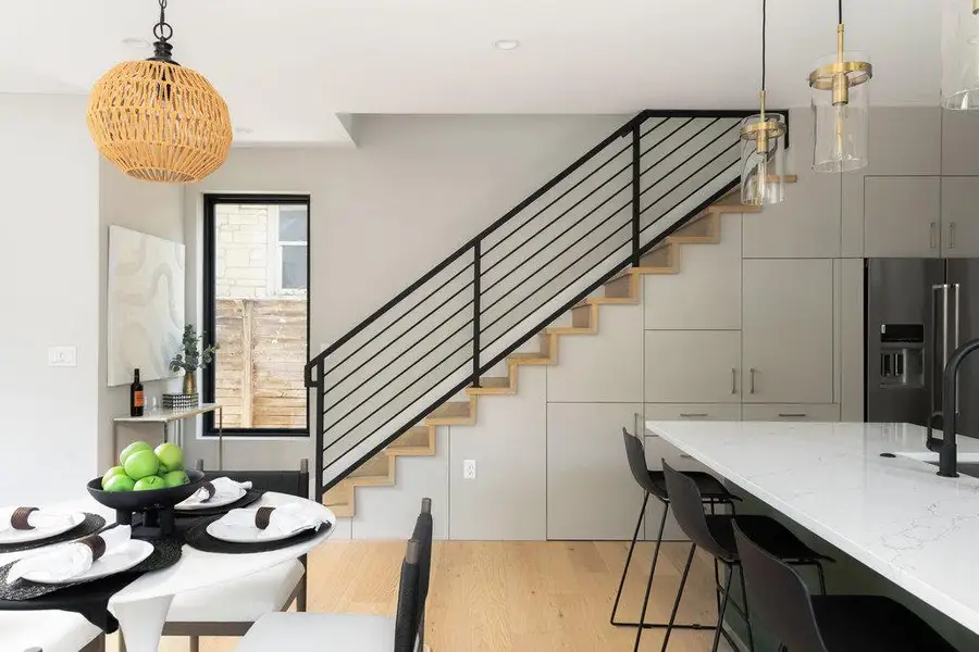 Dining space featuring stairs and light wood-style flooring Dining space featuring stairs and light wood-style flooring