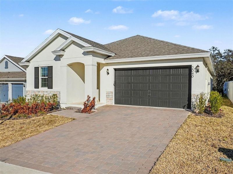 Front exterior of a new home in Hills of Minneola, Minneola, FL, highlighting curb appeal (Image 2). Front exterior of a new home in Hills of Minneola, Minneola, FL, highlighting curb appeal (Image 2).
