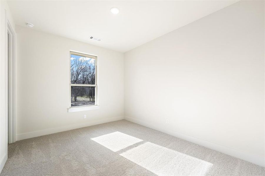 Empty room featuring carpet flooring and baseboards