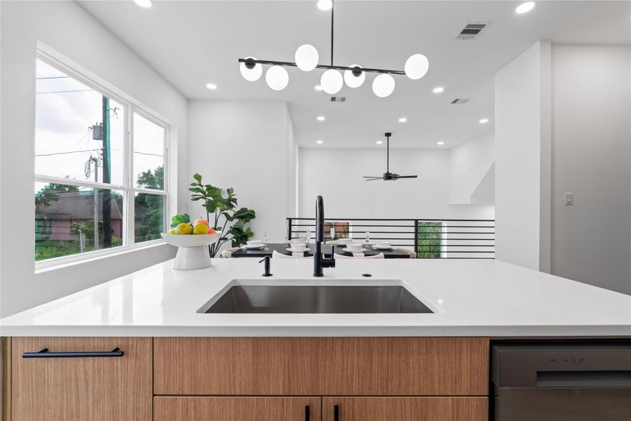 Wake up to sunlight pouring through oversized windows as you prep at this striking island—complete with a matte black faucet, deep undermount sink, and seamless quartz countertops. Designed for daily life and entertaining alike, it’s the perfect perch for morning coffee, casual conversations, or catching golden hour. Wake up to sunlight pouring through oversized windows as you prep at this striking island—complete with a matte black faucet, deep undermount sink, and seamless quartz countertops. Designed for daily life and entertaining alike, it’s the perfect perch for morning coffee, casual conversations, or catching golden hour.