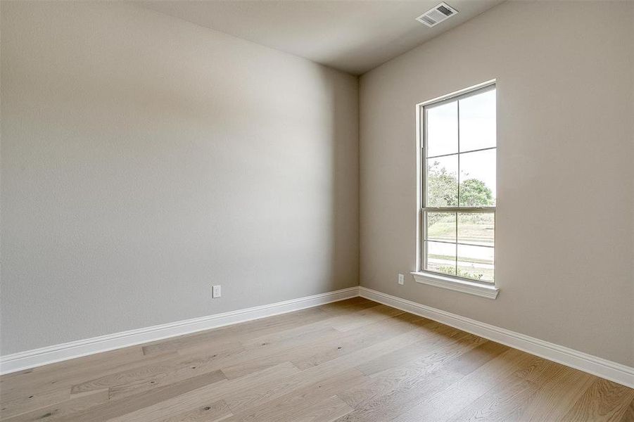 Unfurnished room with light wood-type flooring and plenty of natural light