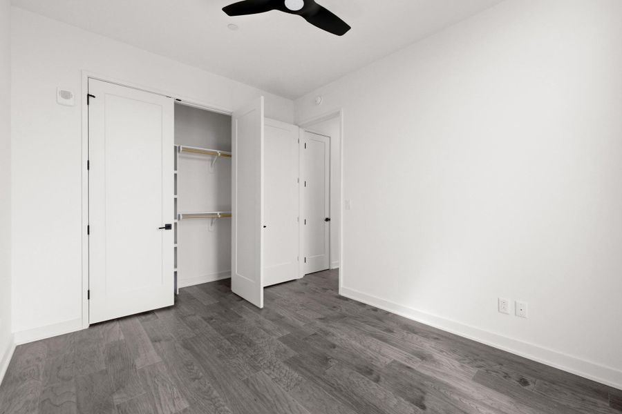 Spacious secondary bedroom with hardwood flooring, recessed lighting, and a ceiling fan