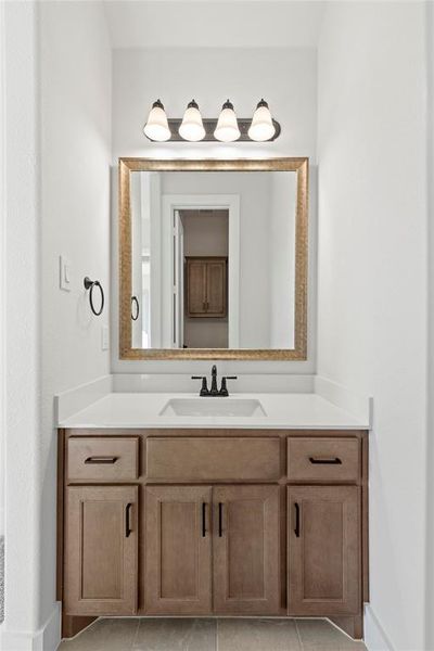 Bathroom with tile patterned floors and vanity