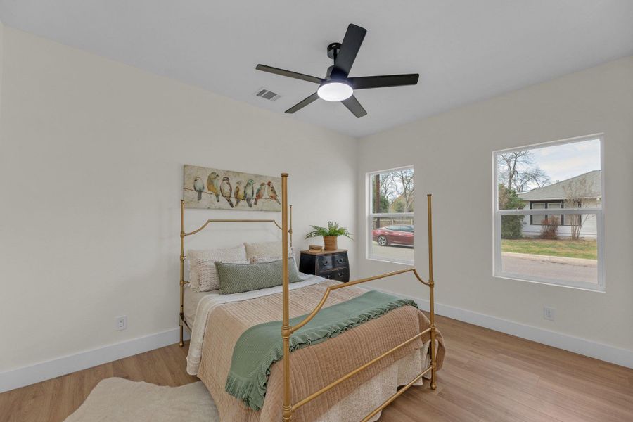 one of 3 additional bedrooms in main house with ceiling fan, connects to Jack and Jill bathroom and closets.