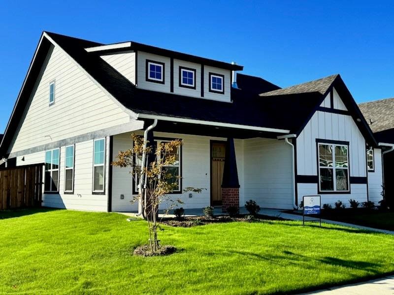 View of front of property with a front yard and a porch