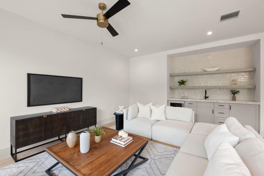 A contemporary game room offers a convenient wet bar and ample space for relaxation. A contemporary game room offers a convenient wet bar and ample space for relaxation.